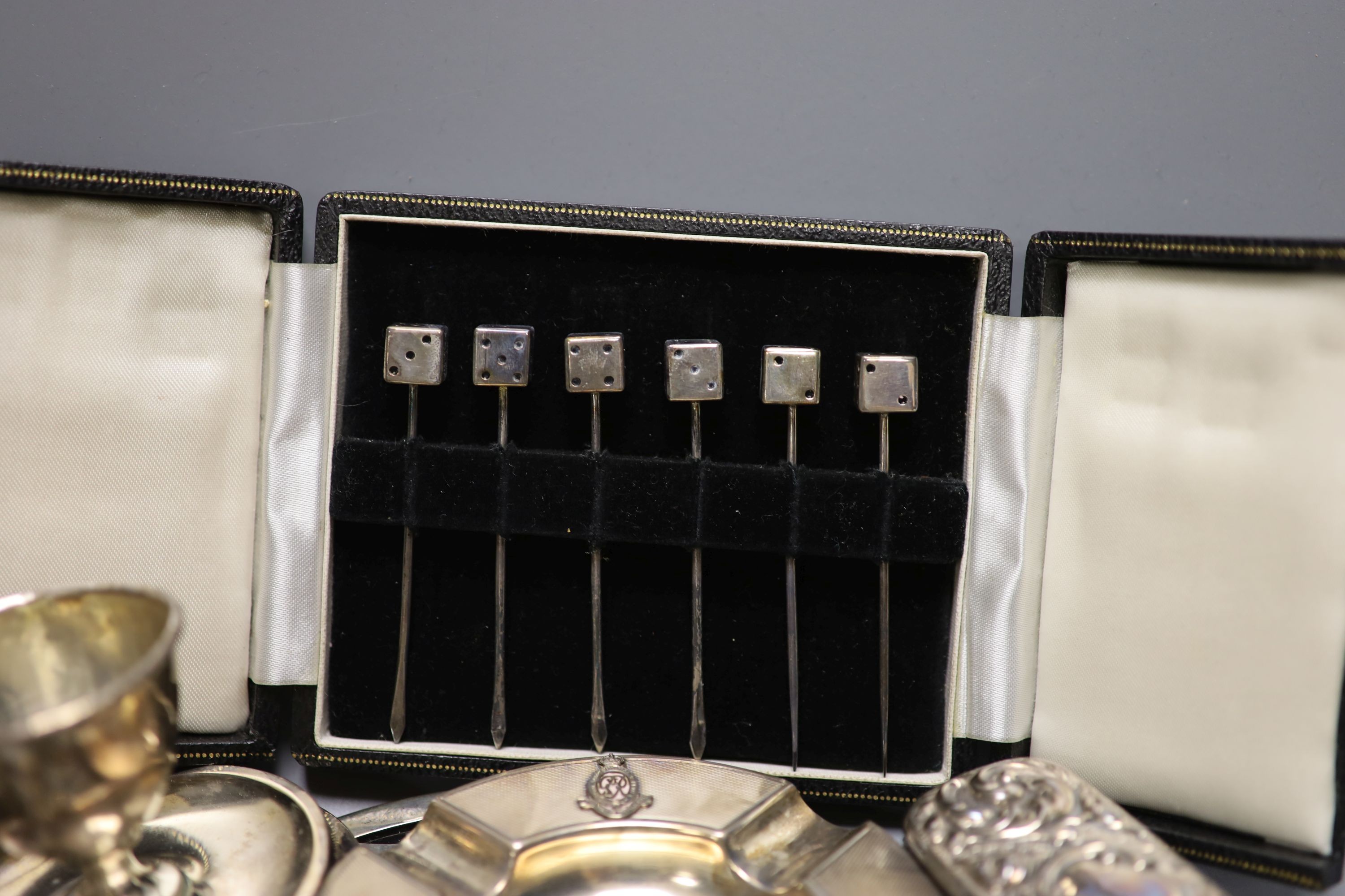 Assorted small silver including cased sets of cocktail sticks, sauceboat, toilet jars, cigarette box, cigarette cases and minor flatware etc.